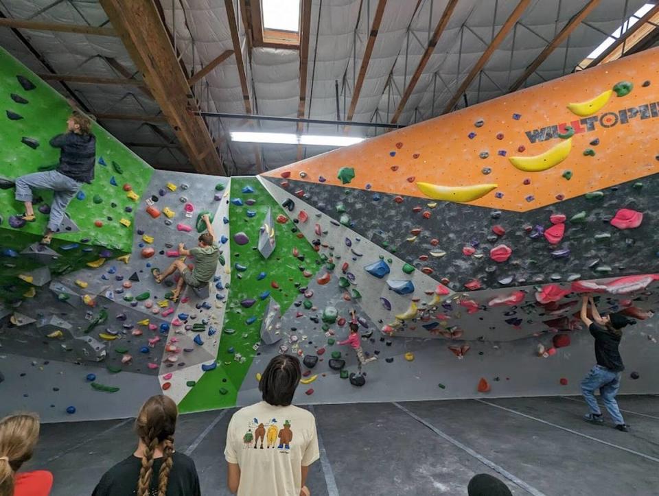 Climbers scale bouldering walls at The Pad Climbing gym in San Luis Obispo. Owner Kristin Tara Horowitz said the business’ 35 gym staff members have struggled with high costs of living in the area, resulting in housing problems for many staffers.