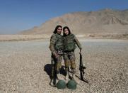 Female soldiers Mohazama Najebi, 18 (R), and Sahar Ibrahimi, 25 (L), from the Afghan National Army (ANA) pose for a picture after shooting exercises at the Kabul Military Training Centre (KMTC) in Kabul, Afghanistan October 26, 2016. REUTERS/Mohammad Ismail