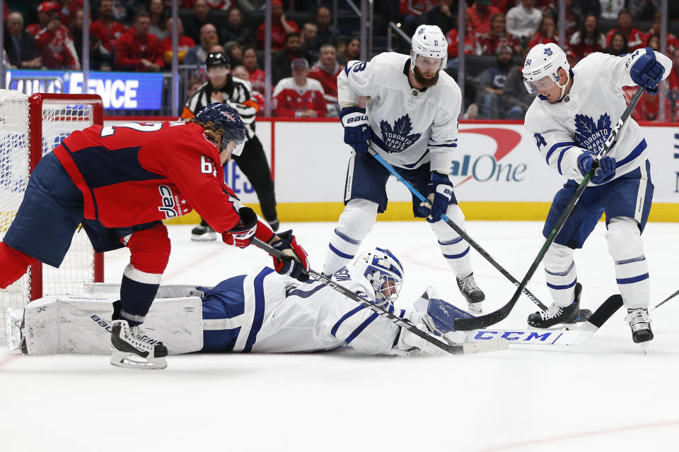 Oct 16, 2019; Washington, DC, USA; Toronto Maple Leafs goaltender Michael Hutchinson (30) makes a save as Washington Capitals left wing Carl Hagelin (62) reaches for the puck during the third period at Capital One Arena. Mandatory Credit: Amber Searls-USA TODAY Sports