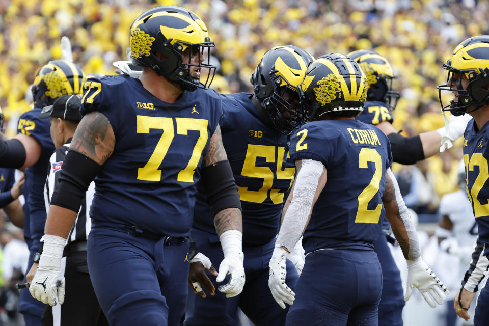 Michigan Wolverines running back Blake Corum (2) is congratulated by teammates after scoring a touchdown in the first half against Penn State. (Rick Osentoski-USA TODAY Sports)