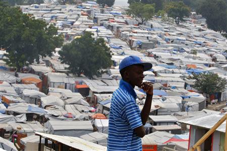 A man pauses while he walks at the Petionville Club golf course camp for victims of the 2010 earthquake set up by the J/P Haitian Relief Organization, co-founded by actor Sean Penn, in Port-au-Prince, in this January 7, 2011 file photo. REUTERS/Kena Betancur/files