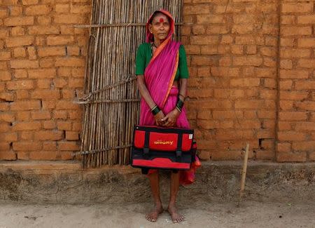 Drupada Pandurangkedar, 70, who studies at Aajibaichi Shaala (Grandmothers' School), poses for a photograph outside her house in Fangane village, India, February 15, 2017. REUTERS/Danish Siddiqui