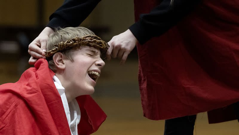 Tyler Lengerich screams while a crown of thorns is placed on his head as the eighth grade class from Saint John the Baptist Middle School presents the Living Stations of the Cross at Juan Diego Catholic High School in Draper on Thursday, March 30, 2023.