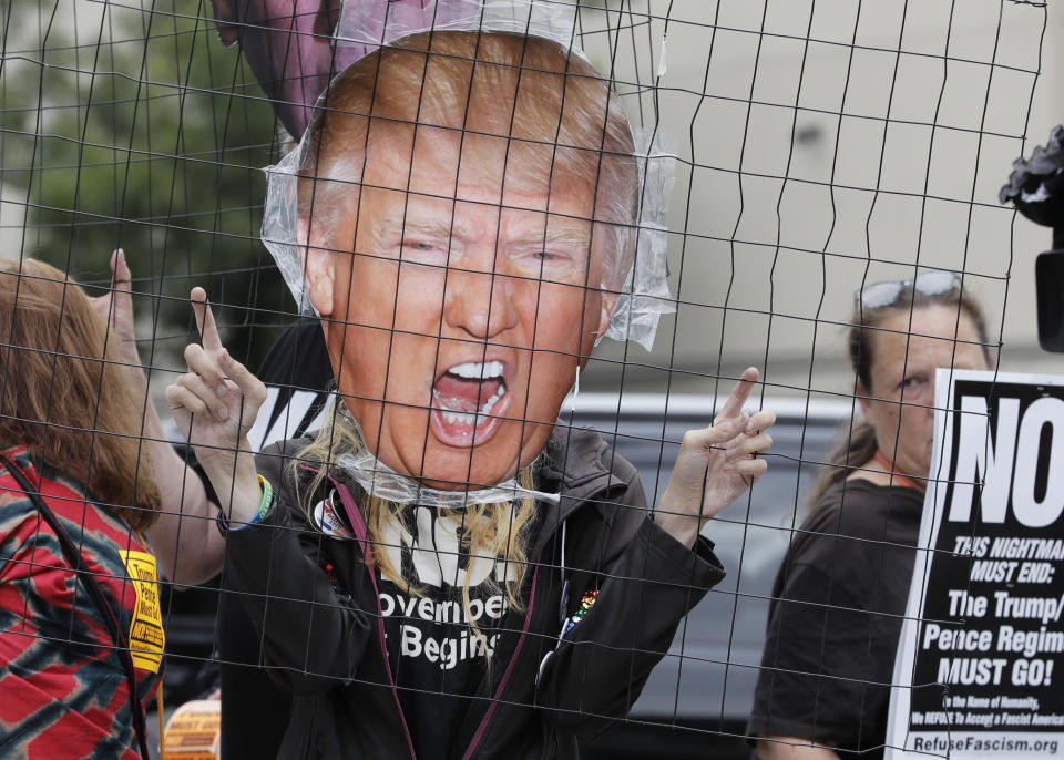 <p>Asuka Jaxx holds a photo of President Donald Trump during a protest, Monday, July 9, 2018, in Seattle, by the group Refuse Fascism, against Trump and his choice of federal appeals Judge Brett Kavanaugh as the president’s second nominee to the Supreme Court. (Photo: Ted S. Warren/AP) </p>