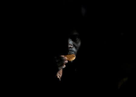 A migrant eats a biscuit on the Migrant Offshore Aid Station (MOAS) ship Topaz Responder after being rescued around 20 nautical miles off the coast of Libya, June 23, 2016. REUTERS/Darrin Zammit Lupi