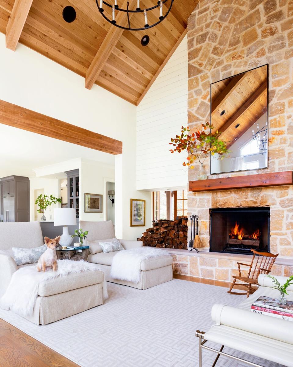 Cabin Living Room with Stone Fireplace and White Walls