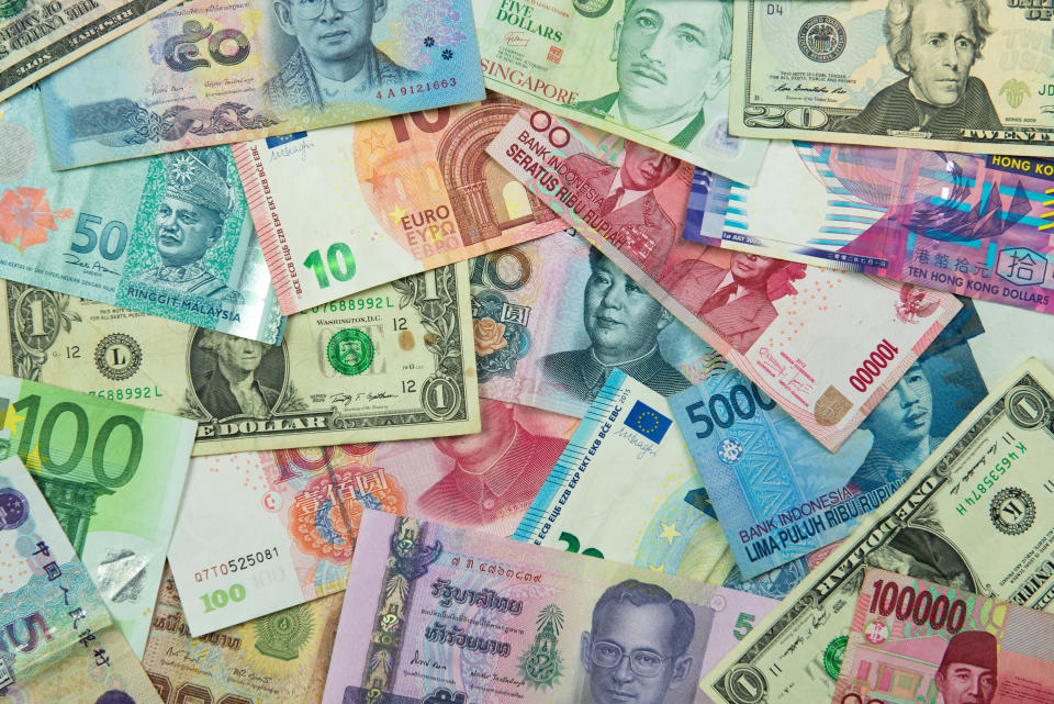 Close up of foreign currency banknotes forming background