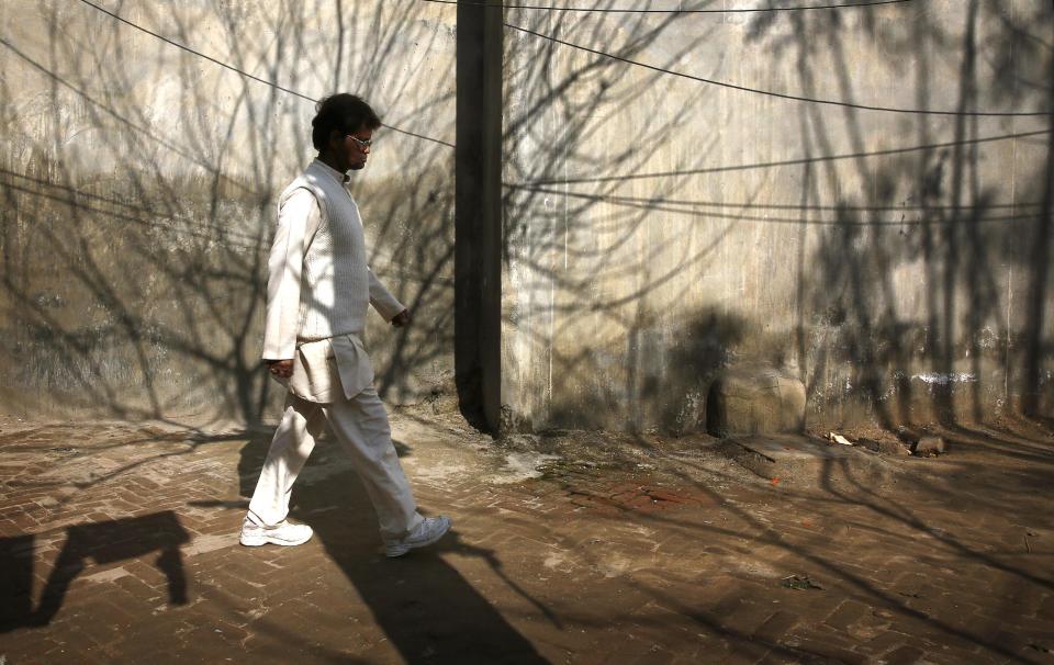 In this Feb. 5, 2014 photo, leprosy-affected Indian Ashok Kumar walks in his compound at a leper colony in New Delhi, India. The stigma of leprosy endures in India, even though the country has made great strides against the disease, which is neither highly contagious nor fatal. Now the number of new annual cases has risen slightly after years of steady decline, and medical experts say the enormous fear surrounding leprosy is hindering efforts to finally eliminate it. (AP Photo/Manish Swarup)