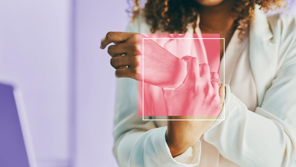 Shot of an unrecognisable businesswoman experiencing wrist pain while working in a modern office