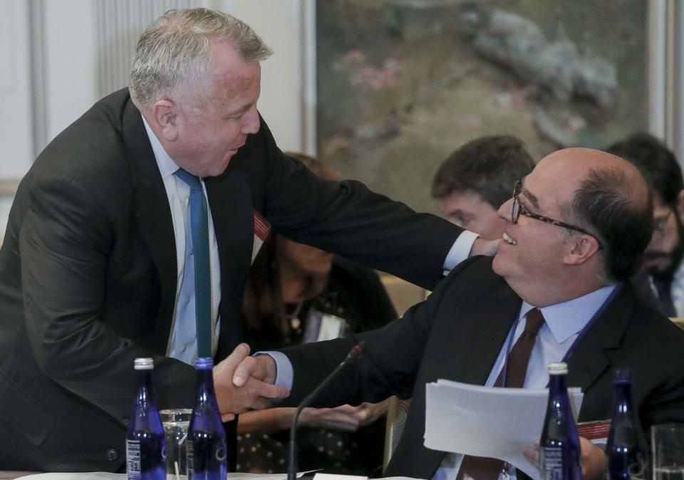 U.S. Deputy Secretary of State John Sullivan, left, and Julio Borges, an opposition leader in Venezuela, shake hands before a meeting organized by the OAS, to discuss sanctions on Venezuela, Monday Sept. 23, 2019, in New York. (AP Photo/Bebeto Matthews)