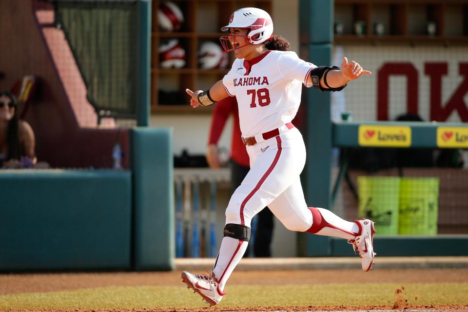 OklahomaÕs Jocelyn Alo celebrates with coach Patty Gasso after hitting a grand slam in the fifth inning of a Bedlam softball game between the University of Oklahoma Sooners (OU) and the Oklahoma State UniversityÕs Cowgirls (OSU) at Marita Hynes Field in Norman, Okla., Saturday, May 7, 2022.