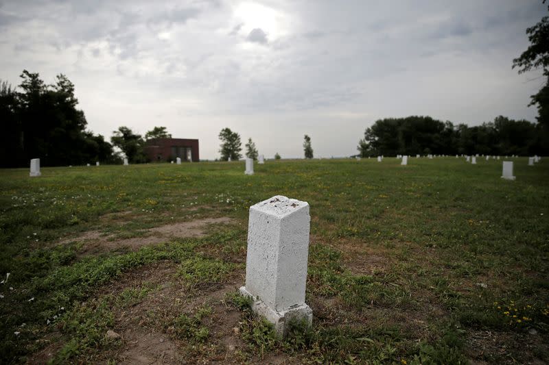 FILE PHOTO: Stones marking mass graves stand on Hart Island, the former location of a prison and hospital that is a potter's field burial site of as many as one million people, in New York