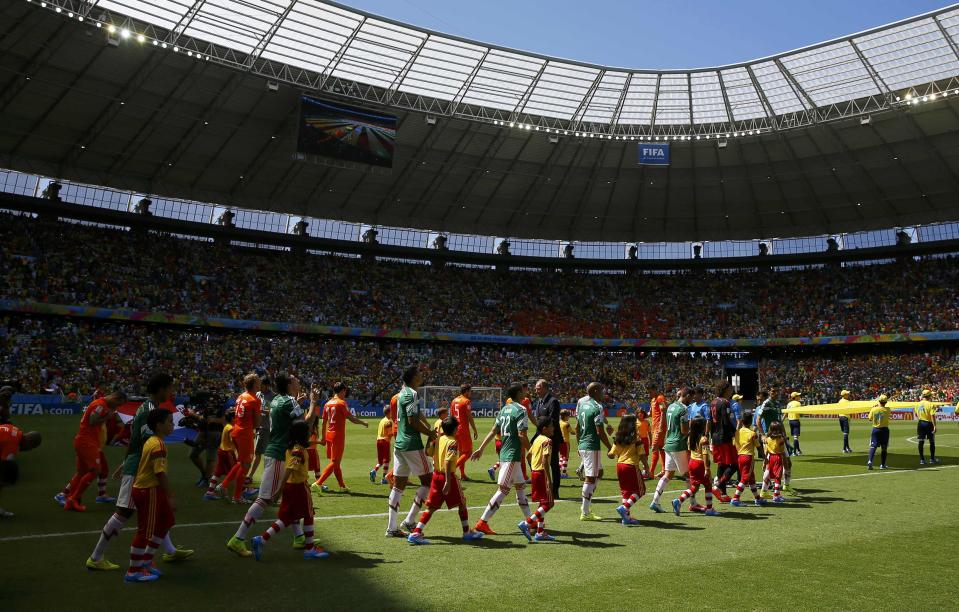 National soccer players of Netherlands and Mexico enter the pitch to sing their national anthems before their 2014 World Cup round of 16 game at the Castelao arena in Fortaleza