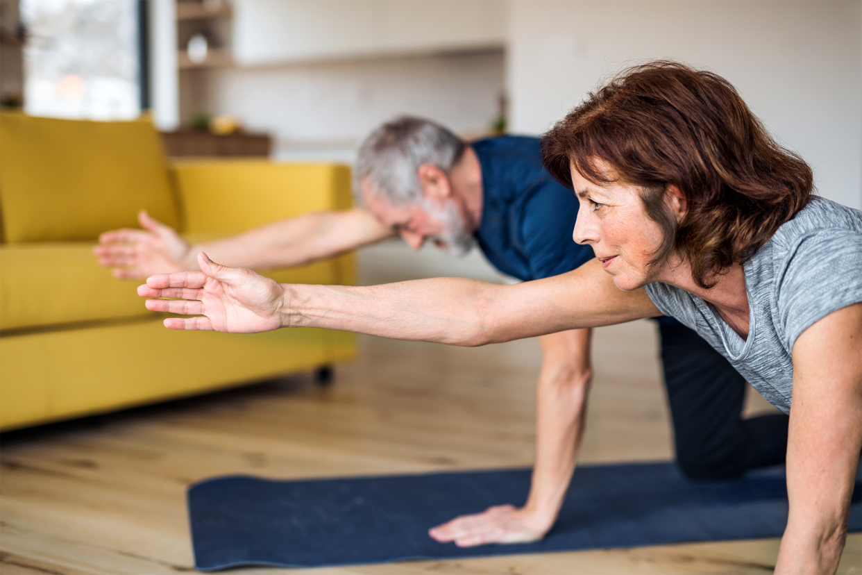 Senior couple exercising at home