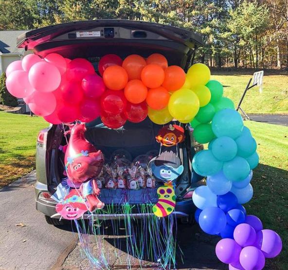 <p>Trick-or-treaters would have sunshine in their pockets and good souls in their feet when they see this cheery <em>Trolls</em>-themed trunk-or-treat setup. The balloon arch really makes it!</p><p><a href="https://www.instagram.com/p/CHSwRB8FE7j/" rel="nofollow noopener" target="_blank" data-ylk="slk:See more @balloonsandbeyondct »;elm:context_link;itc:0;sec:content-canvas" class="link "><em>See more @balloonsandbeyondct »</em></a></p>