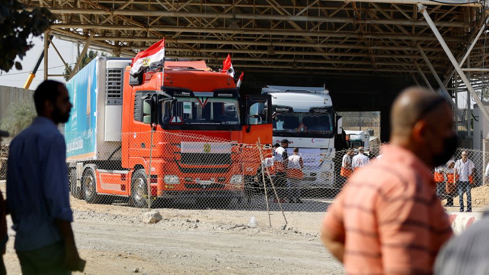 Trucks carrying aid arrive at the Palestinian side of the border with Egypt in Rafah in southern Gaza, on October 21. - Ibraheem Abu Mustafa/Reuters