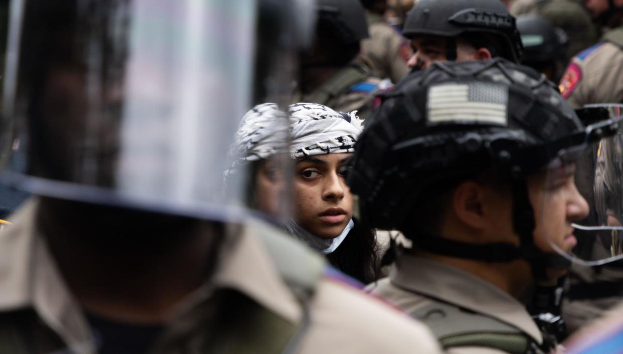 <span>An arrested protester among state troopers during a walkout organized by the Palestine Solidarity Committee at the University of Texas at Austin on 24 April.</span><span>Photograph: Lorianne Willett/The Daily Texan</span>