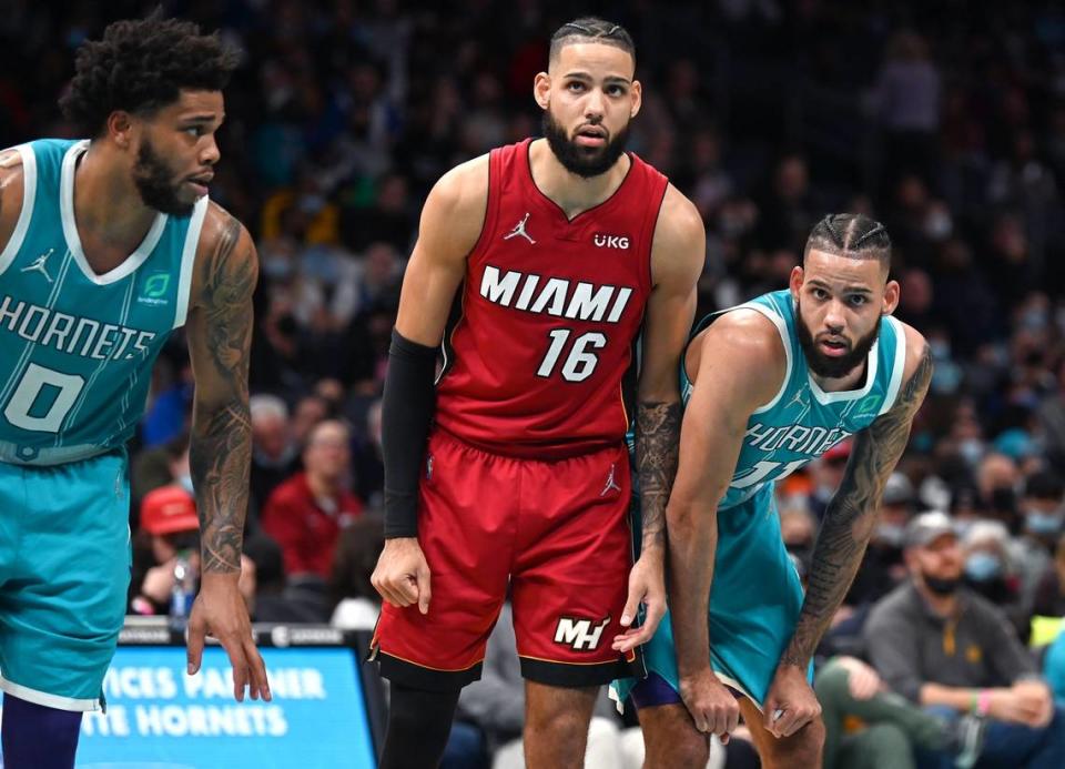 Miami Heat forward Caleb Martin, center, lines up next to his brother Charlotte Hornets forward Cody Martin, right, along the lane during second half action at Spectrum Center on Saturday, February 5, 2022 in Charlotte, NC. The Heat defeated the Hornets 104-86.