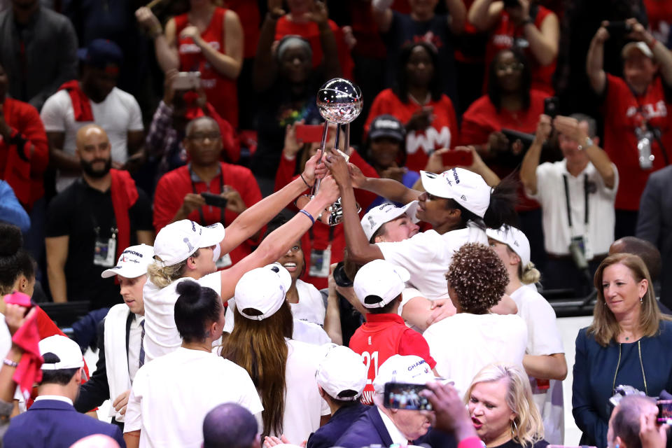 Members of the Washington Mystics celebrate after defeating the Connecticut Sun.