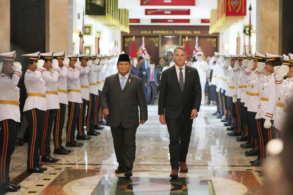 Indonesian Defense Minister Prabowo Subianto, center left, walks with Australian Deputy Prime Minister and Defense Minister Richard Marles, center right, following their meeting in Jakarta, Indonesia, Friday, Feb. 23, 2024. (AP Photo/Achmad Ibrahim)