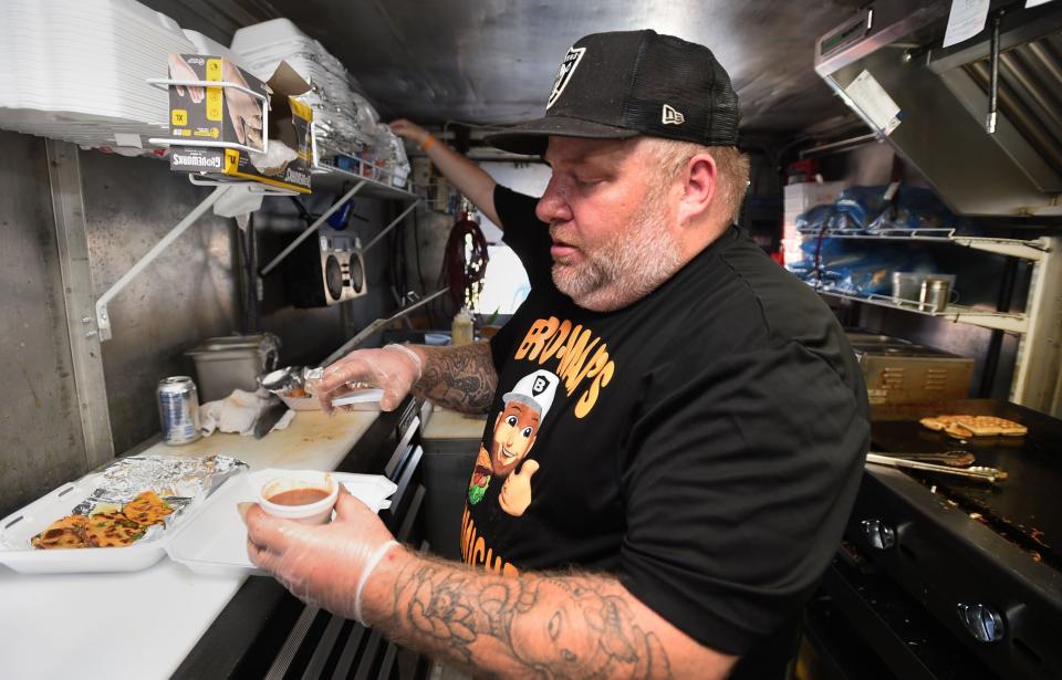 Stephen Stanbro, owner of Bro Man's Sammiches food truck, serves customers June 23, 2021. Stanbro is selling the food truck and moving his operation into the old George's Restaurant.
