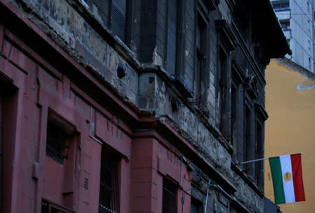 A dilapidated building shows bullet marks from the 1956 anti-Communist uprising, with the revolutionary flag posted on the front, insignia removed, in Budapest, Hungary, October 20, 2016. REUTERS/Laszlo Balogh