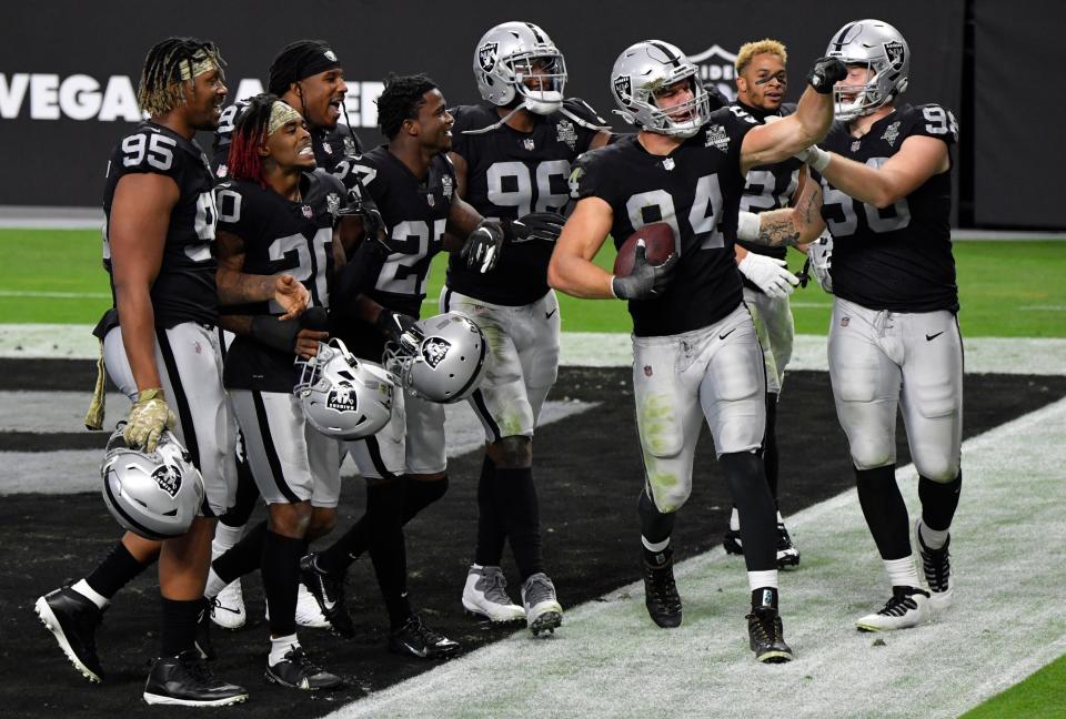 Las Vegas Raiders defensive end Carl Nassib celebrates with teammates after intercepting a pass during the second half against the Denver Broncos during an NFL football game, Sunday, Nov. 15, 2020, in Las Vegas.