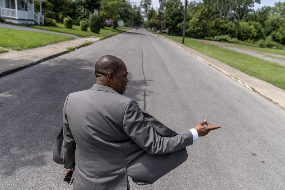 Rev. Jimmie Hardaway Jr. walks through the street outside Trinity Baptist Church Sunday, Aug. 20, 2023, in Niagara Falls, N.Y. “I’m really not free if I know that there’s someone who can do harm and I can’t do anything to protect them,” says Hardaway, whose city struggles with one of the state’s highest rates of violent crime. (AP Photo/David Goldman)