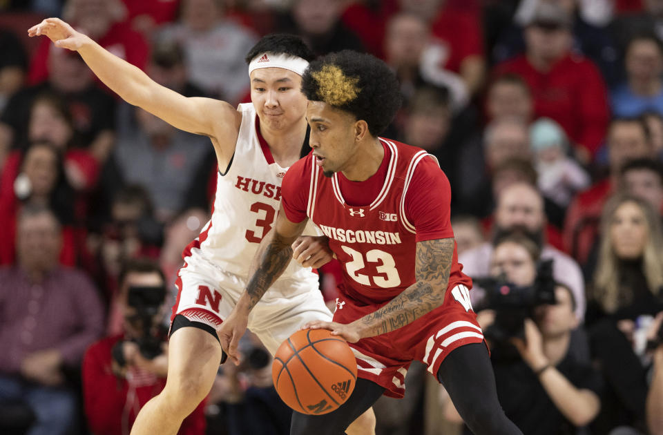 Nebraska's Keisei Tominaga, left, guards Wisconsin's Chucky Hepburn (23) during the first half of an NCAA college basketball game Thursday, Feb. 1, 2024, in Lincoln, Neb. (AP Photo/Rebecca S. Gratz)