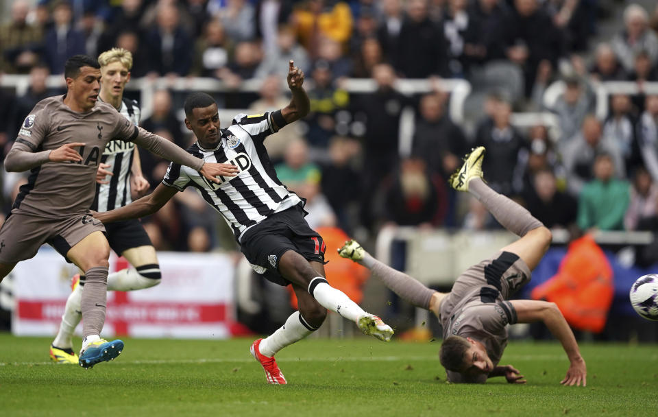 Newcastle United's Alexander Isak, centre, scores the opening goal during the English Premier League soccer match between Newcastle United and Tottenham Hotspur at St. James' Park in Newcastle, England, Saturday, April 13, 2024. (Owen Humphreys/PA via AP)