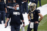 New Orleans Saints head coach Sean Payton talks with quarterback Drew Brees (9) in the first half of an NFL football game against the Los Angeles Chargers in New Orleans, Monday, Oct. 12, 2020. (AP Photo/Butch Dill)