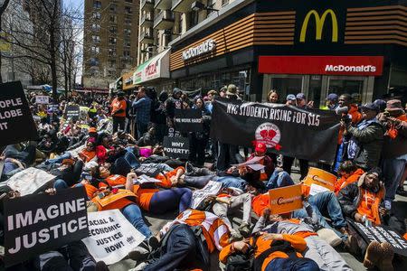 Protesters participate in a 'die in in front of a McDonald's restaurant during demonstrations asking for higher wages in New York, in this file photo taken April 15, 2015. REUTERS/Lucas Jackson/Files