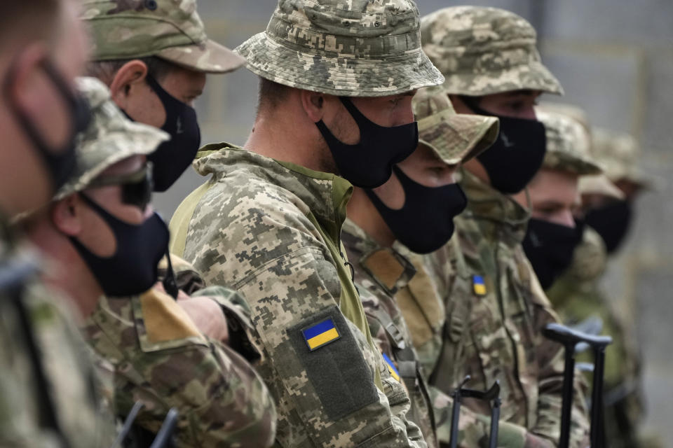 Ukrainian volunteer military recruits take part in an urban battle exercise whilst being trained by British Armed Forces at a military base in Southern England, Monday, Aug. 15, 2022. MOD and British Army as the UK Armed Forces continue to deliver international training of Ukrainian Armed Forces recruits in the United Kingdom.(AP Photo/Frank Augstein)