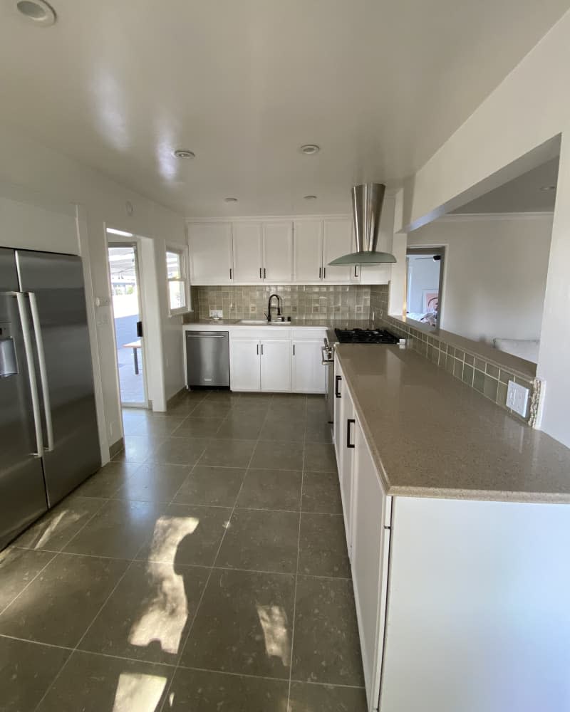 white kitchen with brown tile floor before makeover