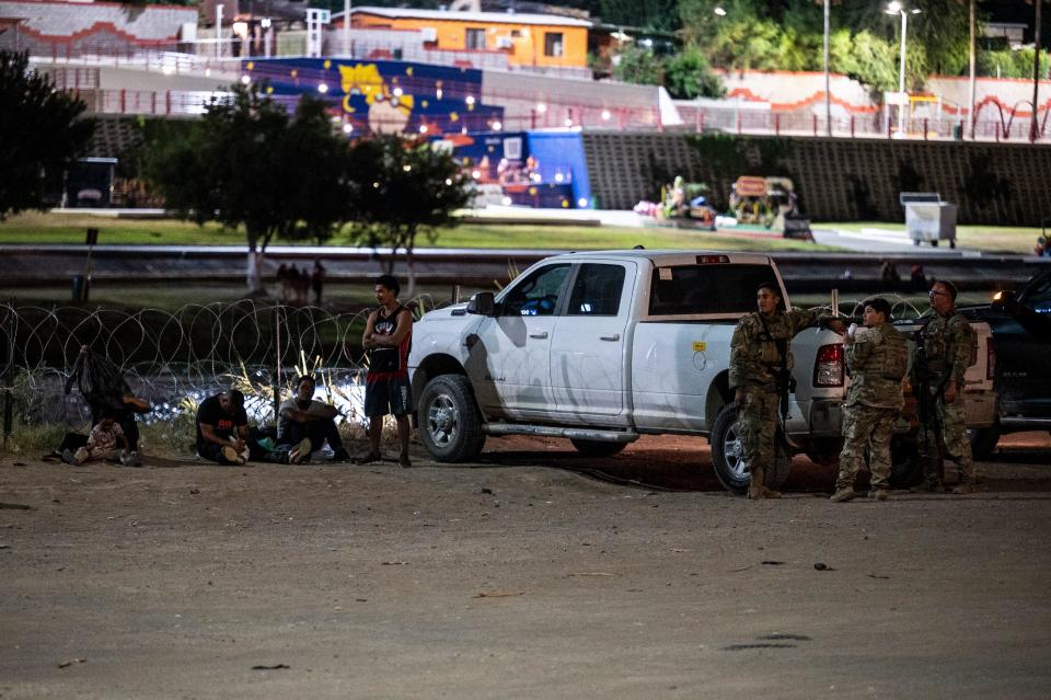 Migrants are apprehended by US Border Patrol and National Guard troops in Eagle Pass, Texas, near the border with Mexico on June 30, 2022.  / Credit: CHANDAN KHANNA/AFP via Getty Images