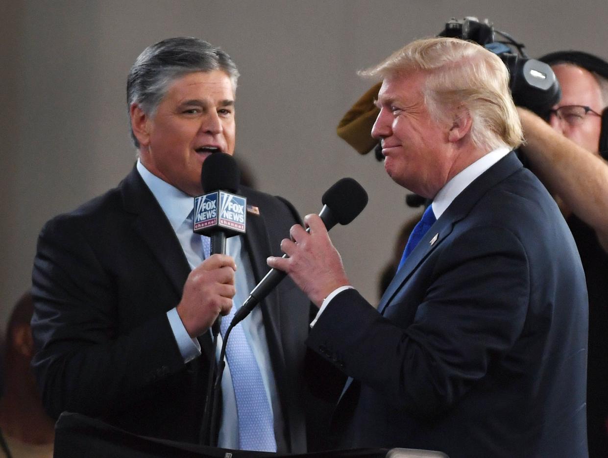 Fox host Sean Hannity  interviews then-President Donald Trump before a campaign rally in Las Vegas on Sept. 20, 2018.