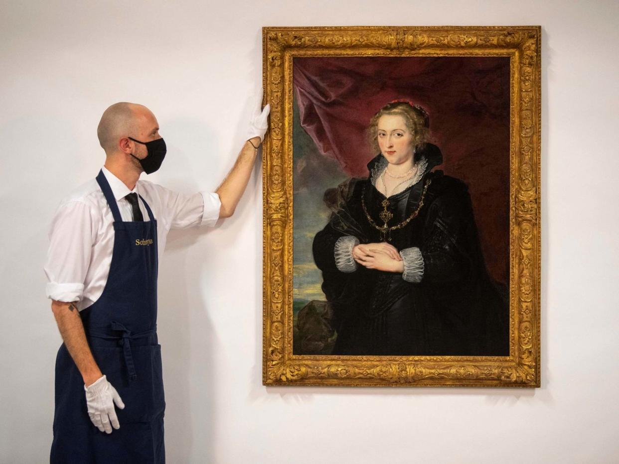 A Sotheby's technician with the Rubens portrait, which was until recently hidden away in a private collection, unknown for much of the 20th century: PA