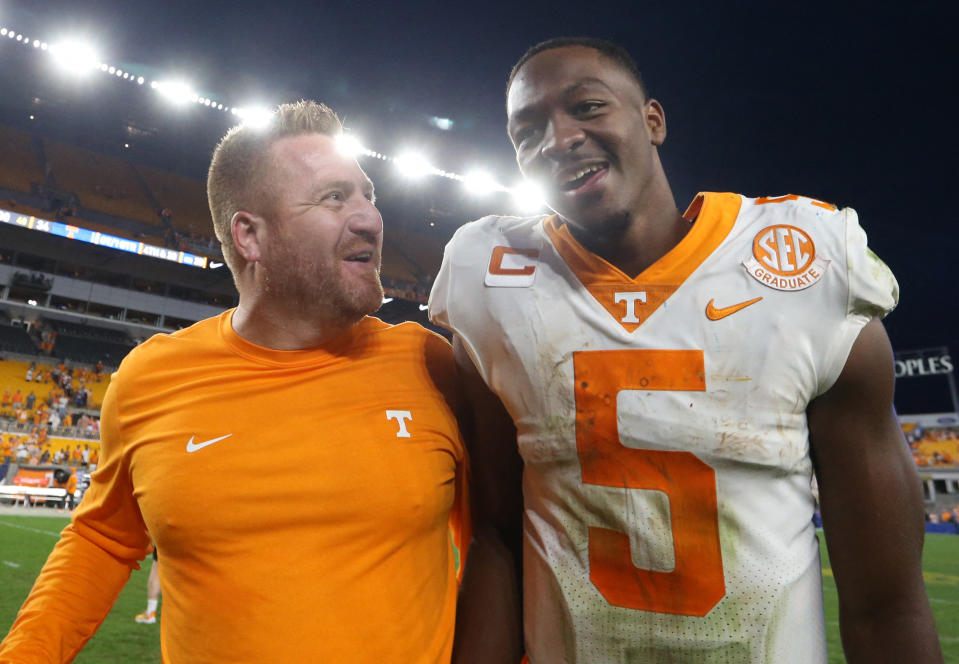 Sep 10, 2022; Pittsburgh, Pennsylvania, USA;  Tennessee Volunteers offensive coordinator Alex Golesh (left) and quarterback Hendon Hooker (5) celebrate as they leave the field after defeating the Pittsburgh Panthers at Acrisure Stadium. Tennessee won 34-27 in overtime. Mandatory Credit: Charles LeClaire-USA TODAY Sports