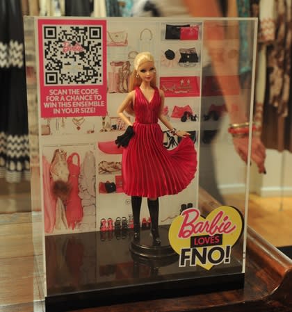 The Barbie Loves Fashion's Night out Tracy Reese doll wears a miniature designer outfit