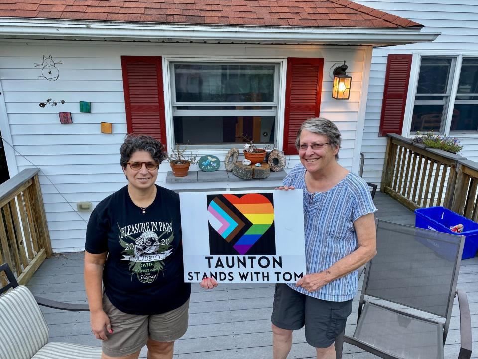 Mija Almeida, left, and Jamie Kelley display a yard sign they helped produce in this file photo. The sign supports Taunton's Tom Anderson, who was attacked in 2020.