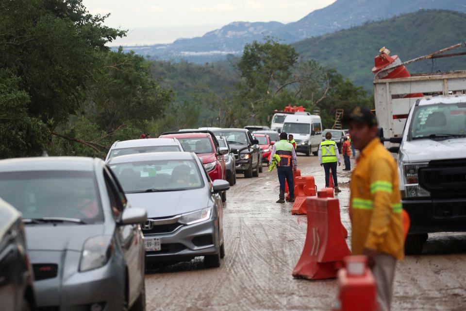 A view shows vehicles trapped by the landslide on parts of the route to Acapulco after Hurricane Otis hit, in the Mexican state of Guerrero (REUTERS)