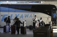 Passengers take the FlyAway bus service as they travel during the week of Thanksgiving, Wednesday, Nov. 22, 2023, at Los Angeles International Airport. The late crush of holiday travelers is picking up steam, with about 2.7 million people expected to board flights on Wednesday and millions more planning to drive or take the train to Thanksgiving celebrations. (AP Photo/Damian Dovarganes)