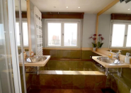 <p>The bathroom, and its deep soaker tub, offers sprawling views of Paris. Perfect for an evening of romance. (Airbnb) </p>