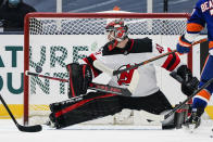 A puck shot by New York Islanders' Brock Nelson gets past New Jersey Devils Scott Wedgewood (41) for a goal during the third period of an NHL hockey game Thursday, Jan. 21, 2021, in Uniondale, N.Y. (AP Photo/Frank Franklin II)