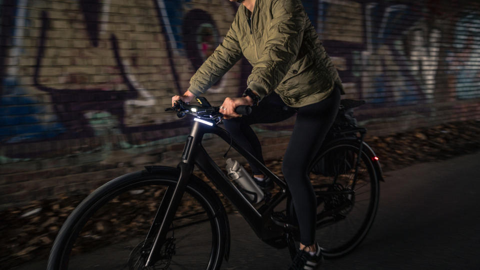 a photo of writer Jessica riding through a dark tunnel on the Orbea Diem 30 with the front lights on show