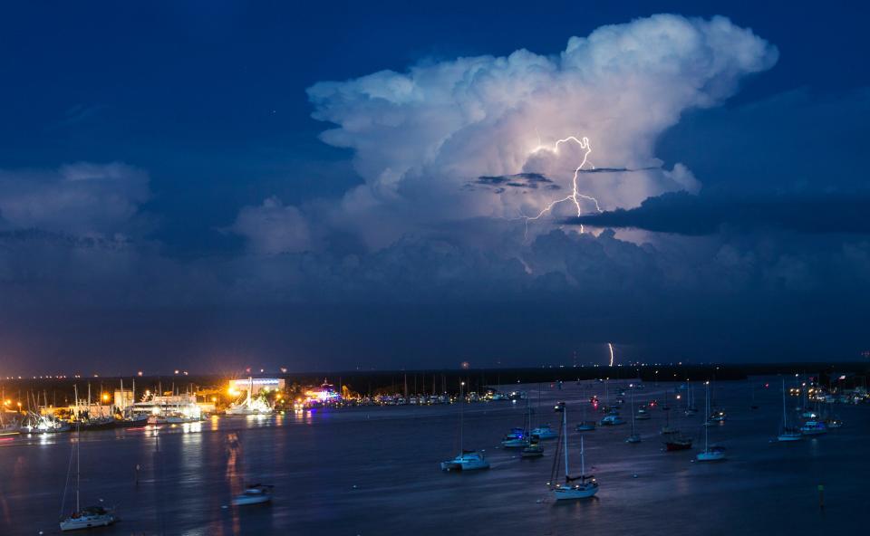 A bolt of lightning lights up a cloud over Matanzas Pass on Fort Myers Beach on Sunday, July 4, 2021. 