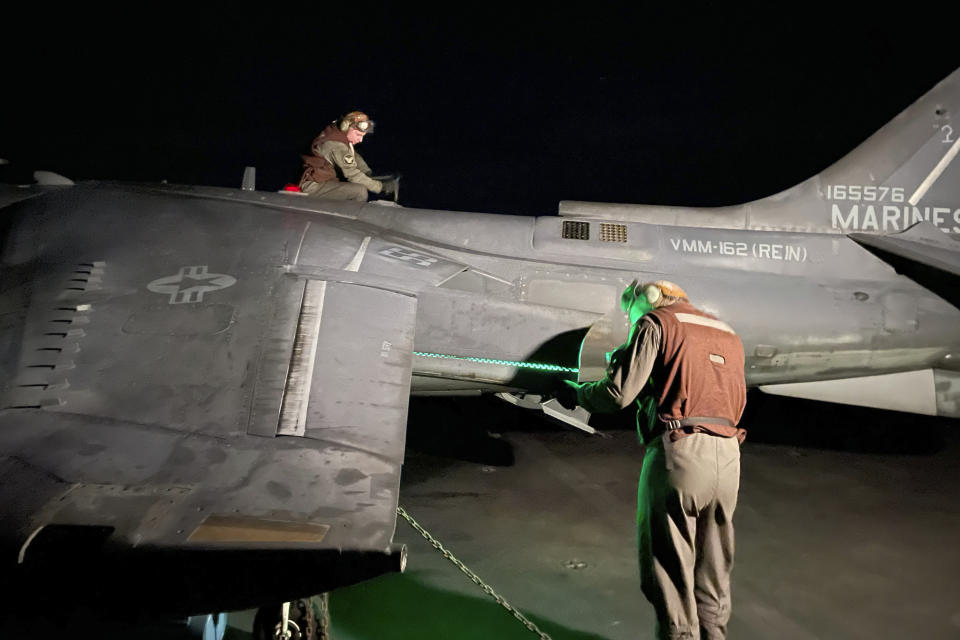 Maintainers inspect an AV8B Harrier jet after a night flight on the USS Bataan in the Aegean Sea, Greece, Thursday, Jan. 18, 2024. The Bataan, an amphibious assault ship, is leading a U.S. Navy task force in the eastern Mediterranean as the United States maintains an increased level of military deployment in the Middle East. (AP Photo/Derek Gatopoulos)