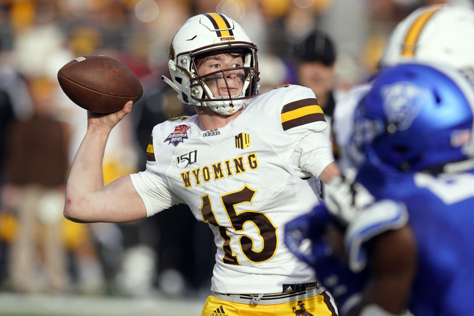 Wyoming quarterback Levi Williams (15) throws down field against Georgia State in the first half of the Arizona Bowl NCAA college football game, Tuesday, Dec. 31, 2019, in Tucson, Ariz. (AP Photo/Rick Scuteri)