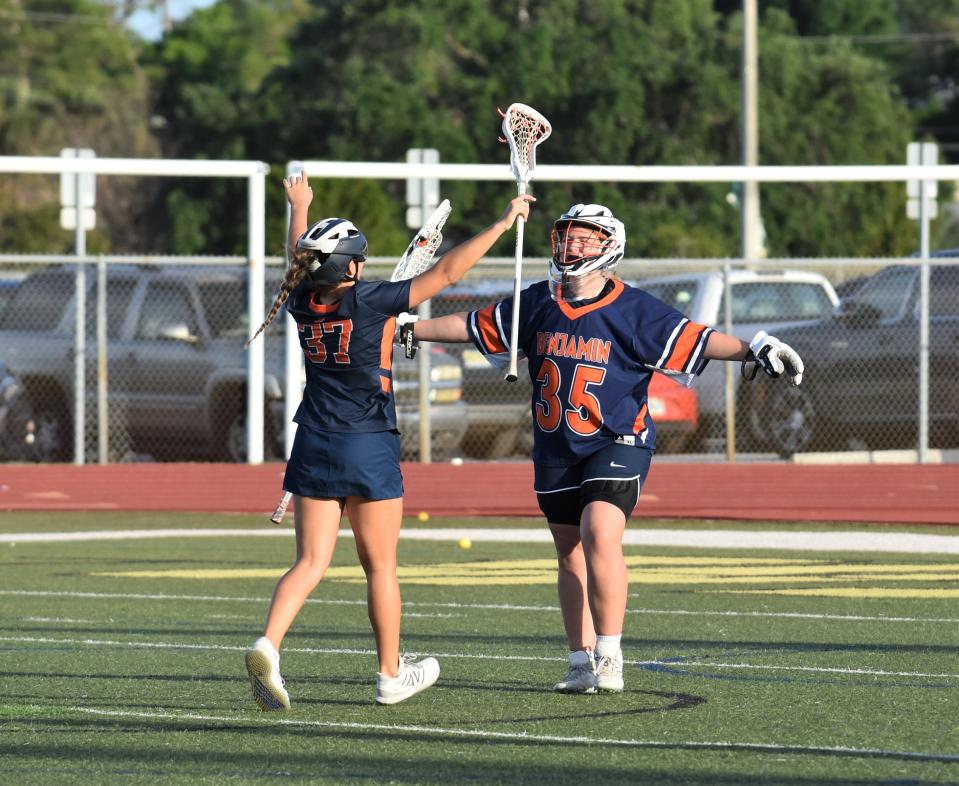 Benjamin's Mackenzie Feiner (left) and Rachel Haueisen (right) embrace after the latter eclipsed a 400-save milestone during the Bucs' win over Jupiter on Mar. 14, 2024.