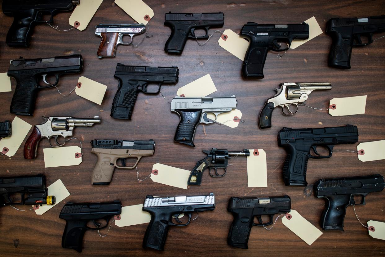 Hand guns confiscated from crime scenes are tagged as evidence inside the LMPD evidence room at 7th Street and Industry Road. Dec. 30, 2021